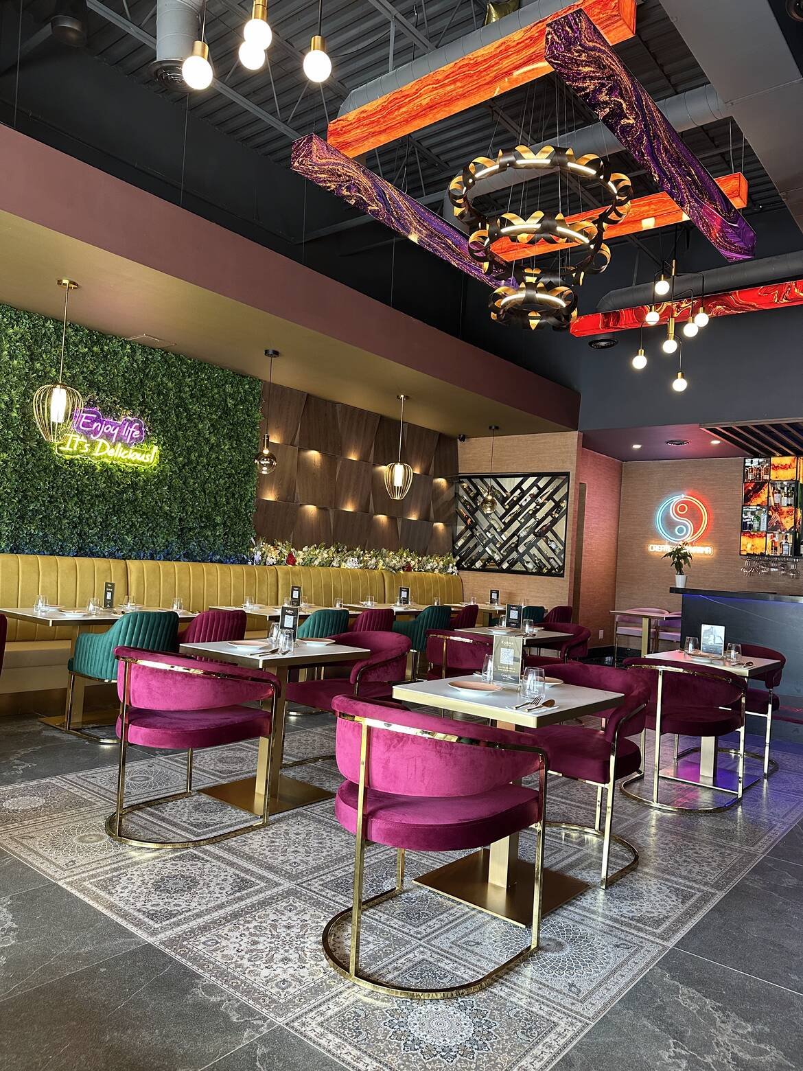 Marble-topped tables and velvet chairs in the Karma dining room